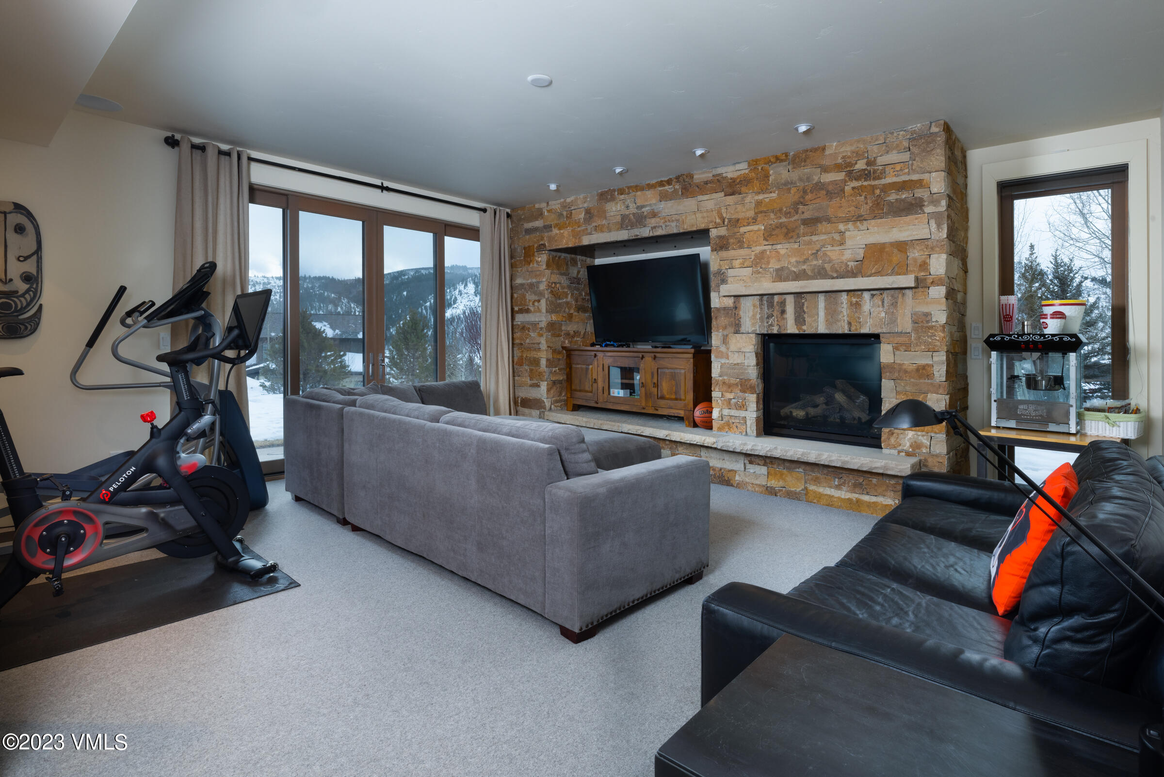 1793 Beard Creek Trail Edwards, CO 81632 - Photo 17 of 28 a living room with furniture a flat screen tv and a fireplace
