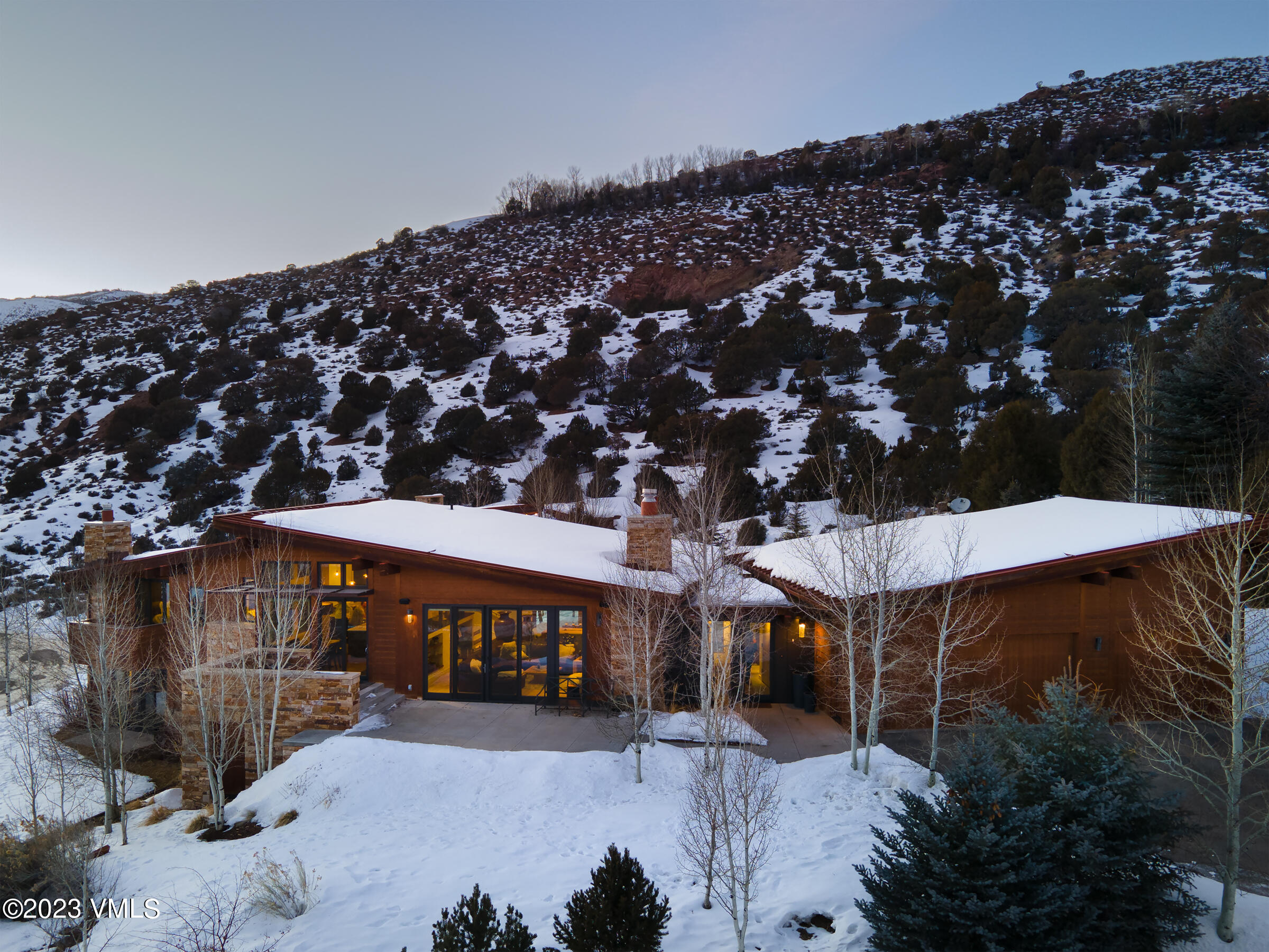 1793 Beard Creek Trail Edwards, CO 81632 - Photo 3 of 28 a view of a big house with a large tree and yard in front of it