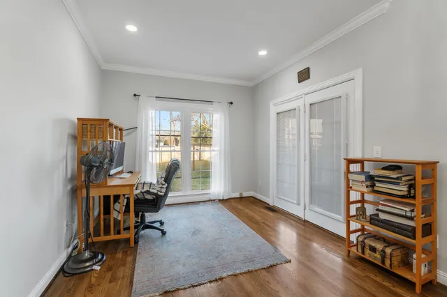 a view of a workspace with furniture and a window
