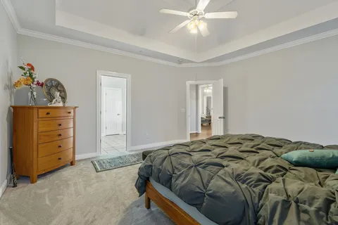 a bed sitting in a bedroom and dresser