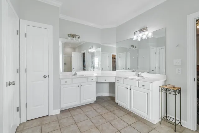 a spacious bathroom with a granite countertop sink a mirror and a