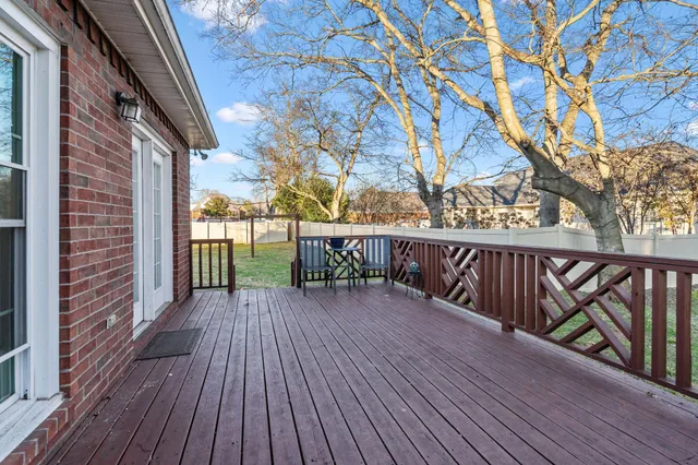 a balcony with wooden floor and fence