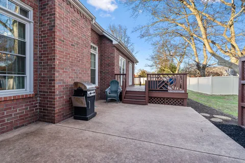 a view of backyard with seating space and trees