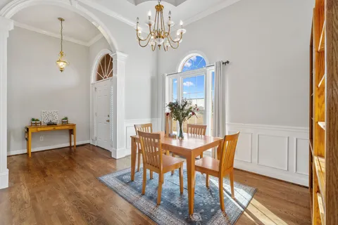 a view of a dining room with furniture and a chandelier