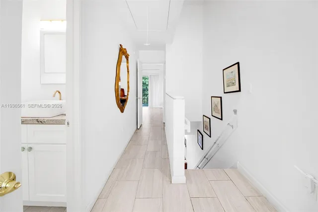 a bathroom with a granite countertop sink and a toilet
