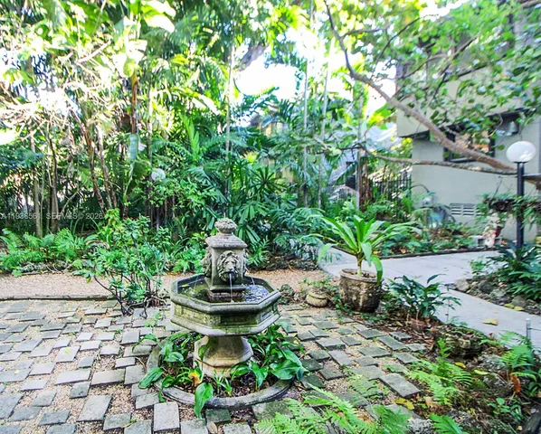 a backyard of a house with a yard and outdoor seating