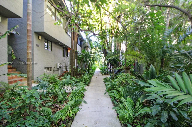 a backyard of a house with a yard and outdoor seating