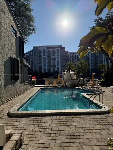 a view of a yard with yellow lighting