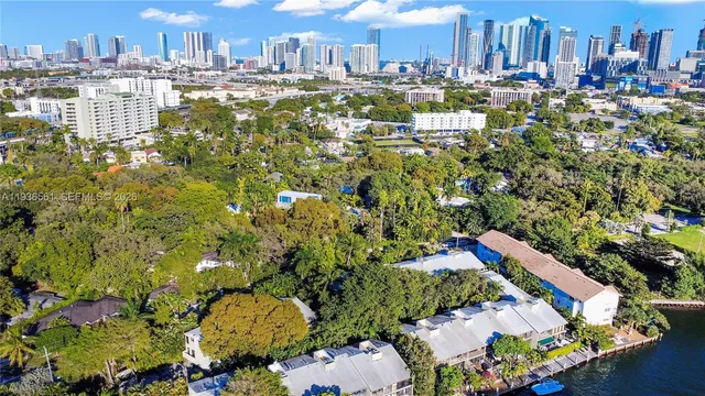 a hallway with white cabinets and window