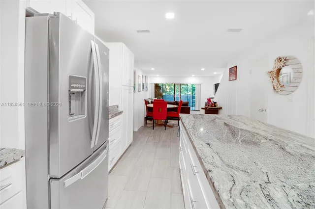 a view of a dining room with furniture a couch and wooden floor