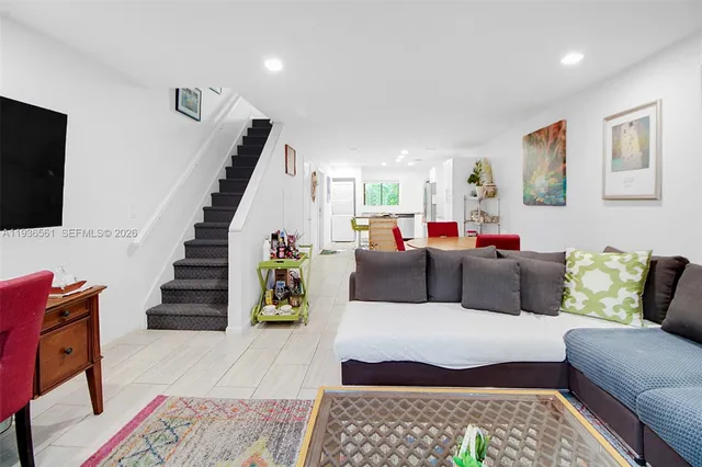 a bedroom with a bed a mirror and desk