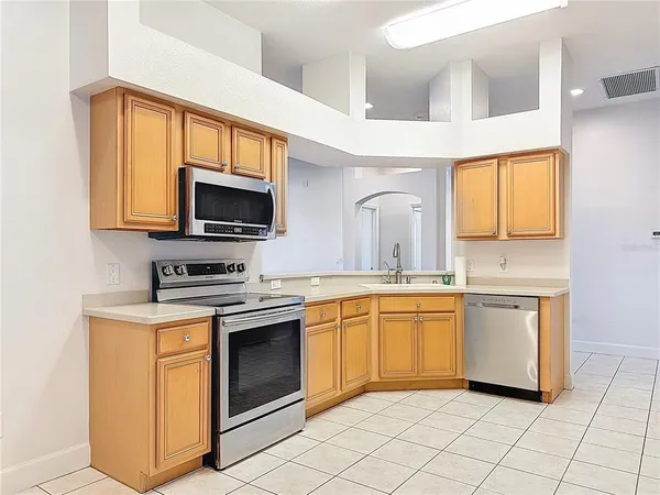 a kitchen with a stove top oven sink and cabinets