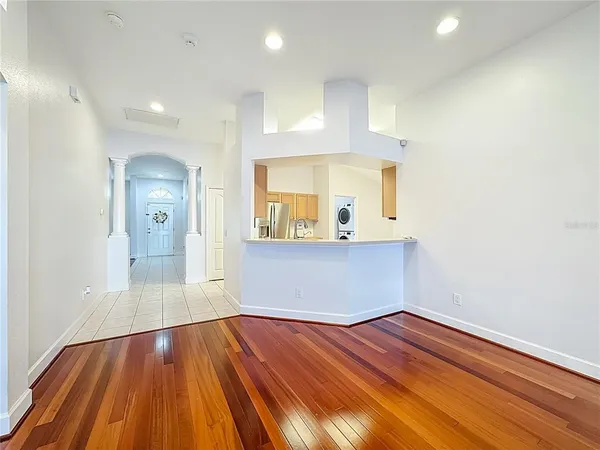 a view of empty room with wooden floor