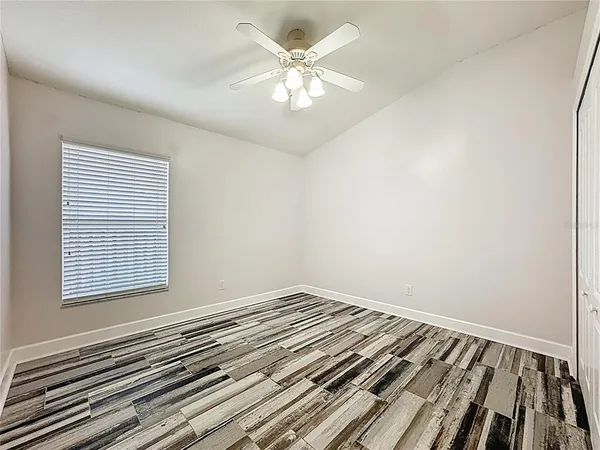 a view of a room with wooden floor