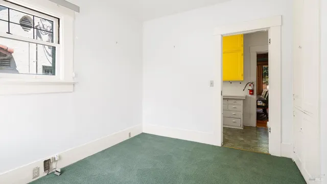 a bathroom with a glass shower door and a window