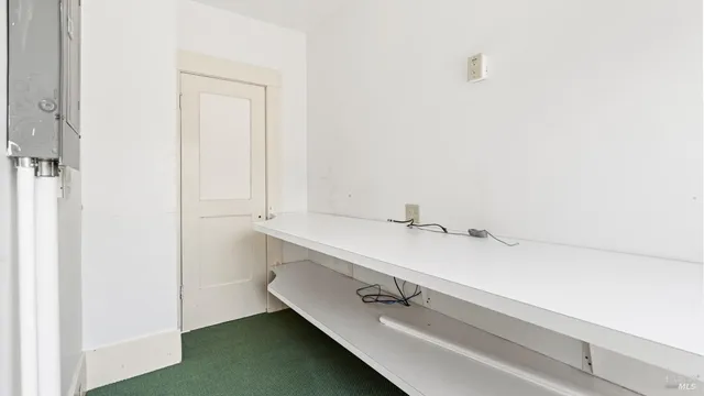 a view of empty room with fireplace and windows