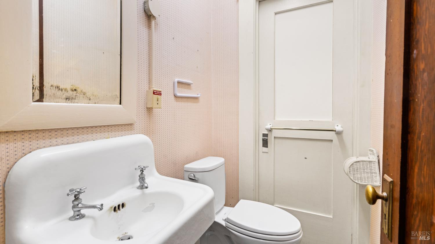 563 Jefferson Street Napa, CA 94559 - Photo 26 of 55 a white toilet sitting next to a bathroom sink