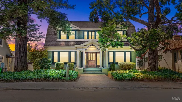 a front view of a house with potted plants
