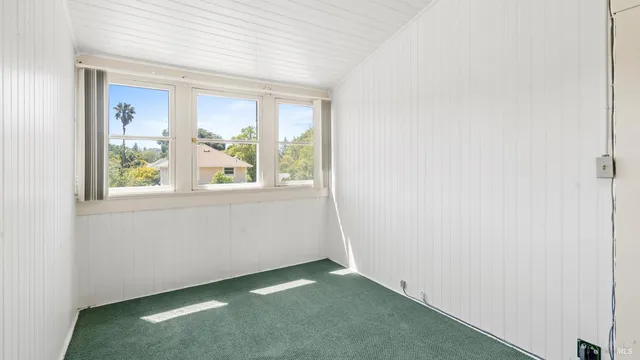 an empty room with windows and closet