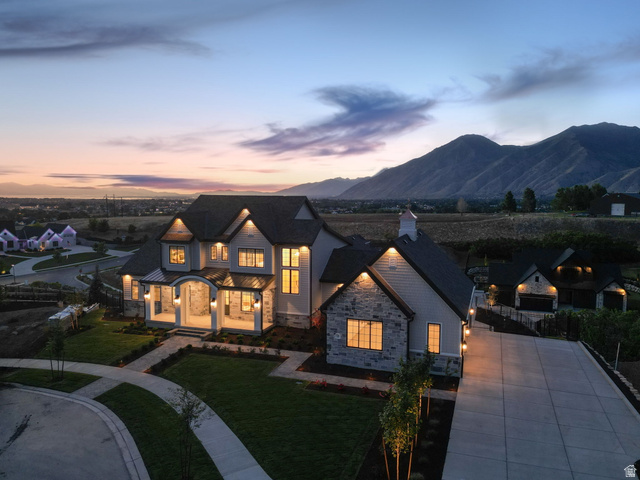 115 East Hidden Ridge Lane, Unit 42 Mapleton, UT 84664 - Photo 96 of 103 Expansive mountain-backdrop property featuring a stone and siding exterior, multi-pane windows, a covered entry porch, and an extended concrete driveway