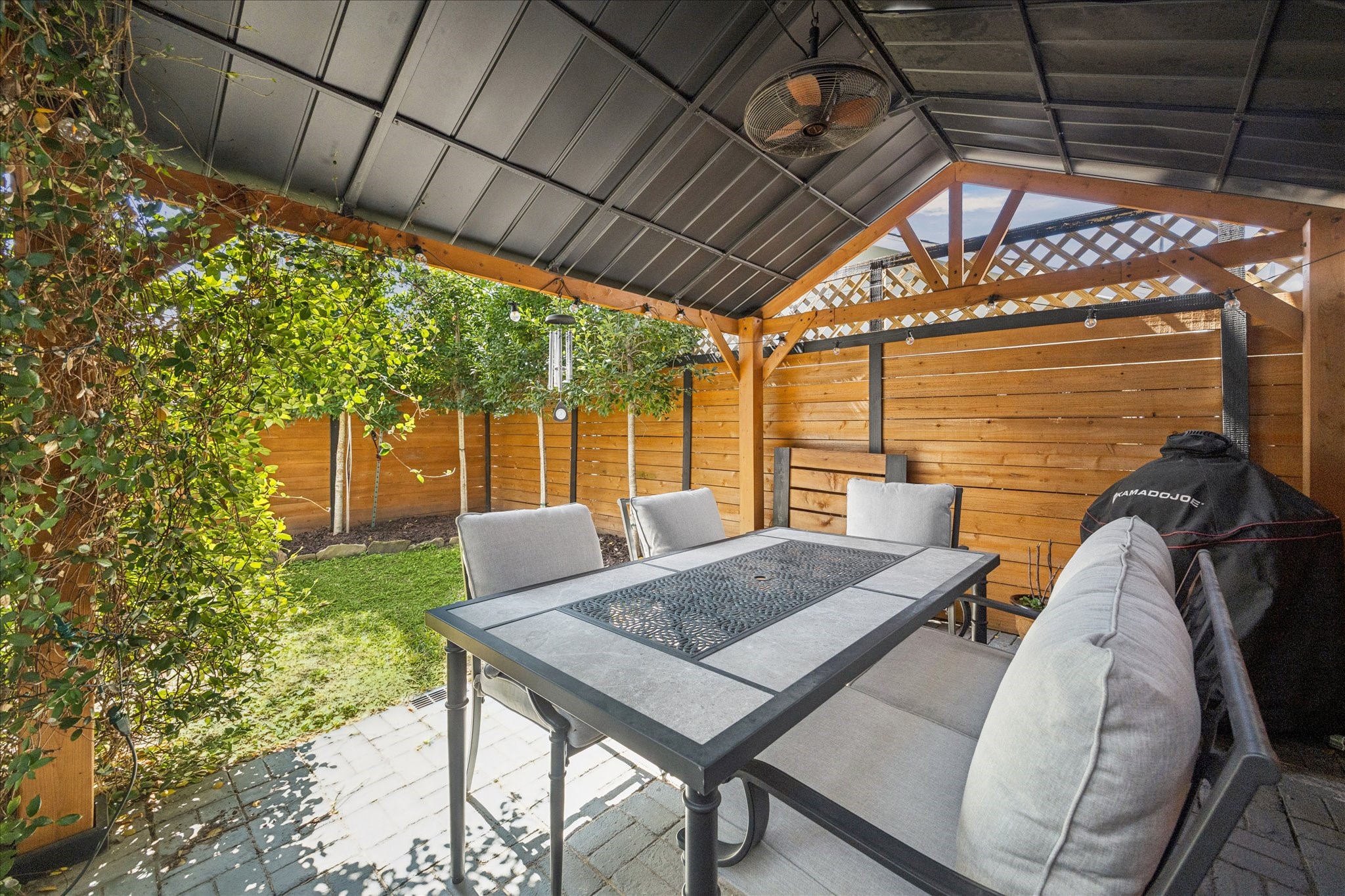 1311 Laird Street Houston, TX 77008 - Photo 14 of 28 An oversized dining pavilion with a ceiling fan is perfect for all-season outdoor use.