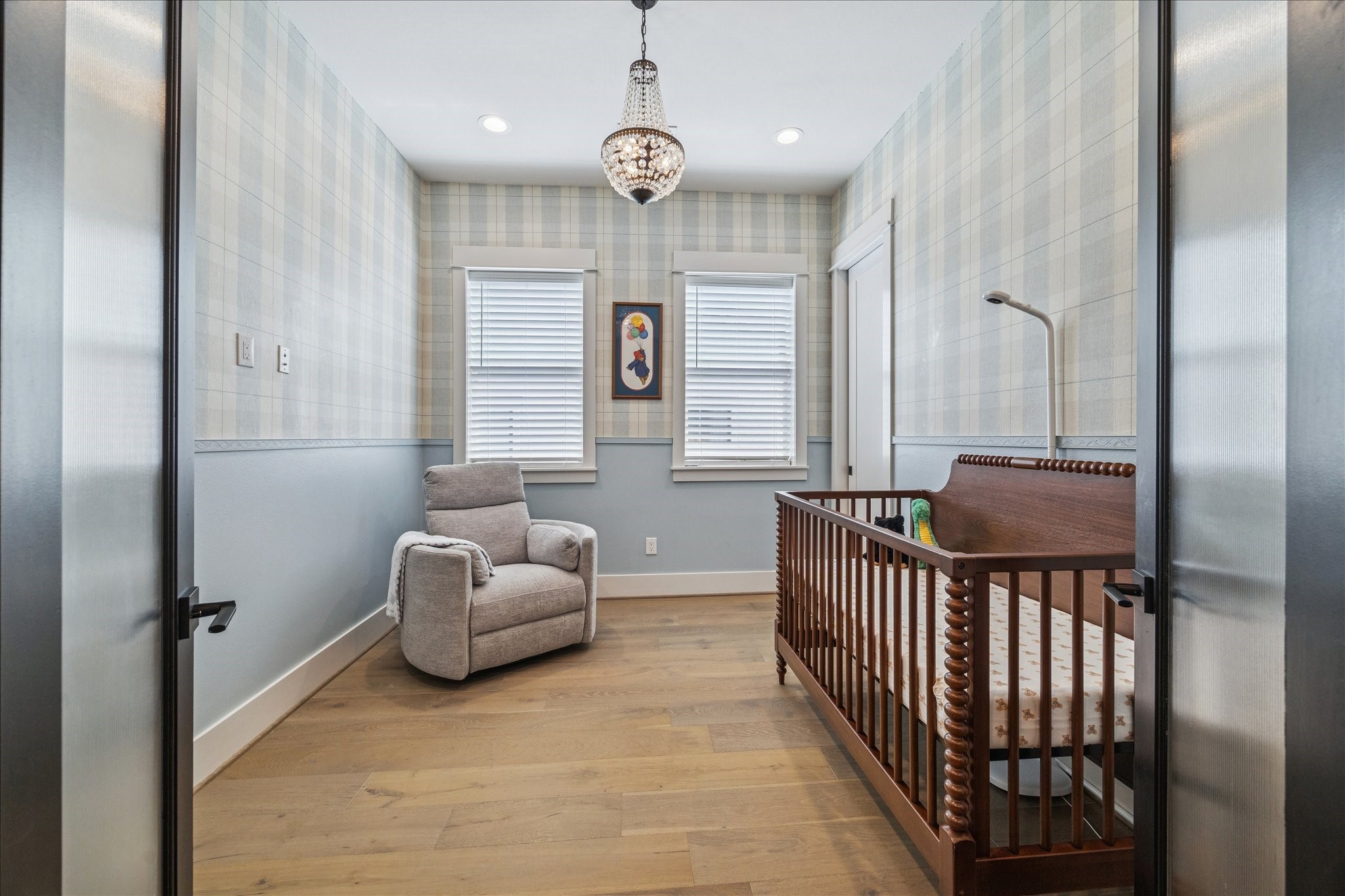 1311 Laird Street Houston, TX 77008 - Photo 15 of 28 French doors open to this charming secondary bedroom featuring southern exposures, wood floors, a lovely crystal chandelier, a roomy closet and designer wallpaper.