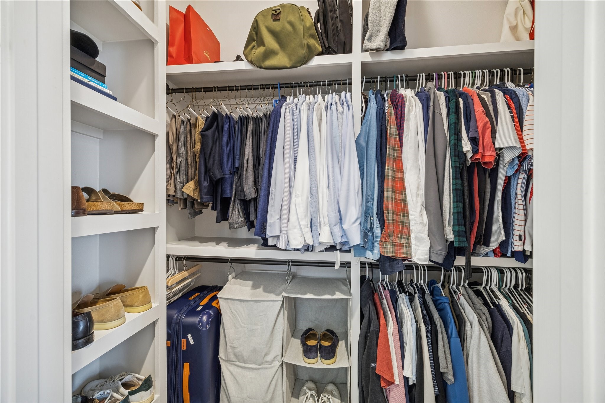 1311 Laird Street Houston, TX 77008 - Photo 27 of 28 The primary bedroom’s second walk-in closet includes floor-to-ceiling shelving and double hanging rods.