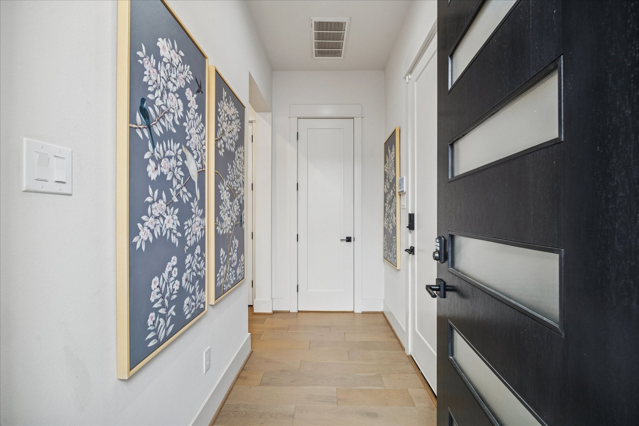 1311 Laird Street Houston, TX 77008 - Photo 4 of 28 The frosted glass-inset entry door welcomes you into a spacious foyer featuring direct garage access and a powder room.