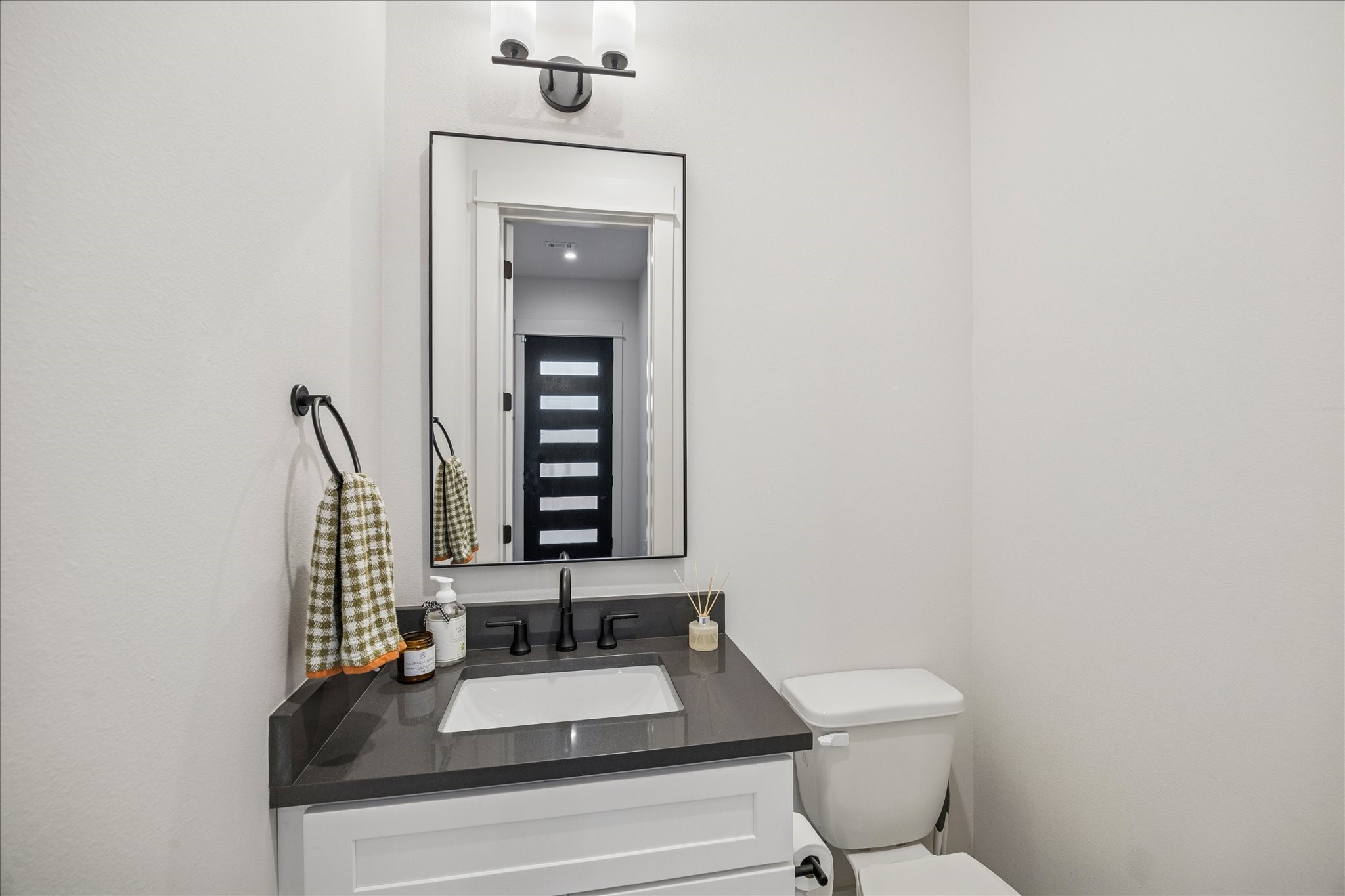 1311 Laird Street Houston, TX 77008 - Photo 10 of 28 Off the entry, the powder room features a roomy vanity and contemporary fixtures.