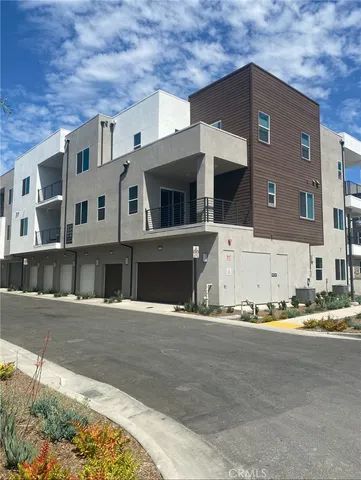 a front view of a house with a road