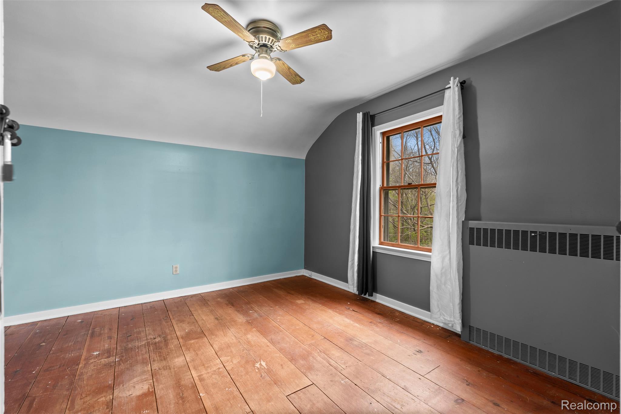 1775 Imlay City Road Lapeer, MI 48446 - Photo 29 of 60 Bonus room with radiator, ceiling fan, light wood-style floors, and vaulted ceiling