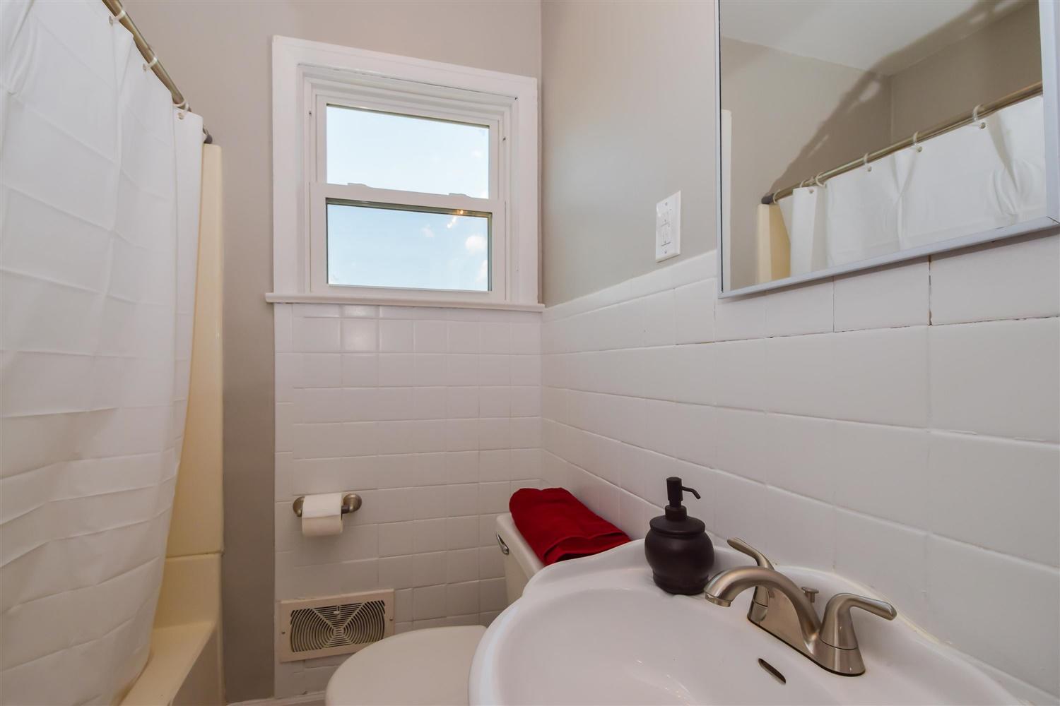 2027 Laura Road Northwest Roanoke, VA 24017 - Photo 11 of 26 a bathroom with a toilet and a sink