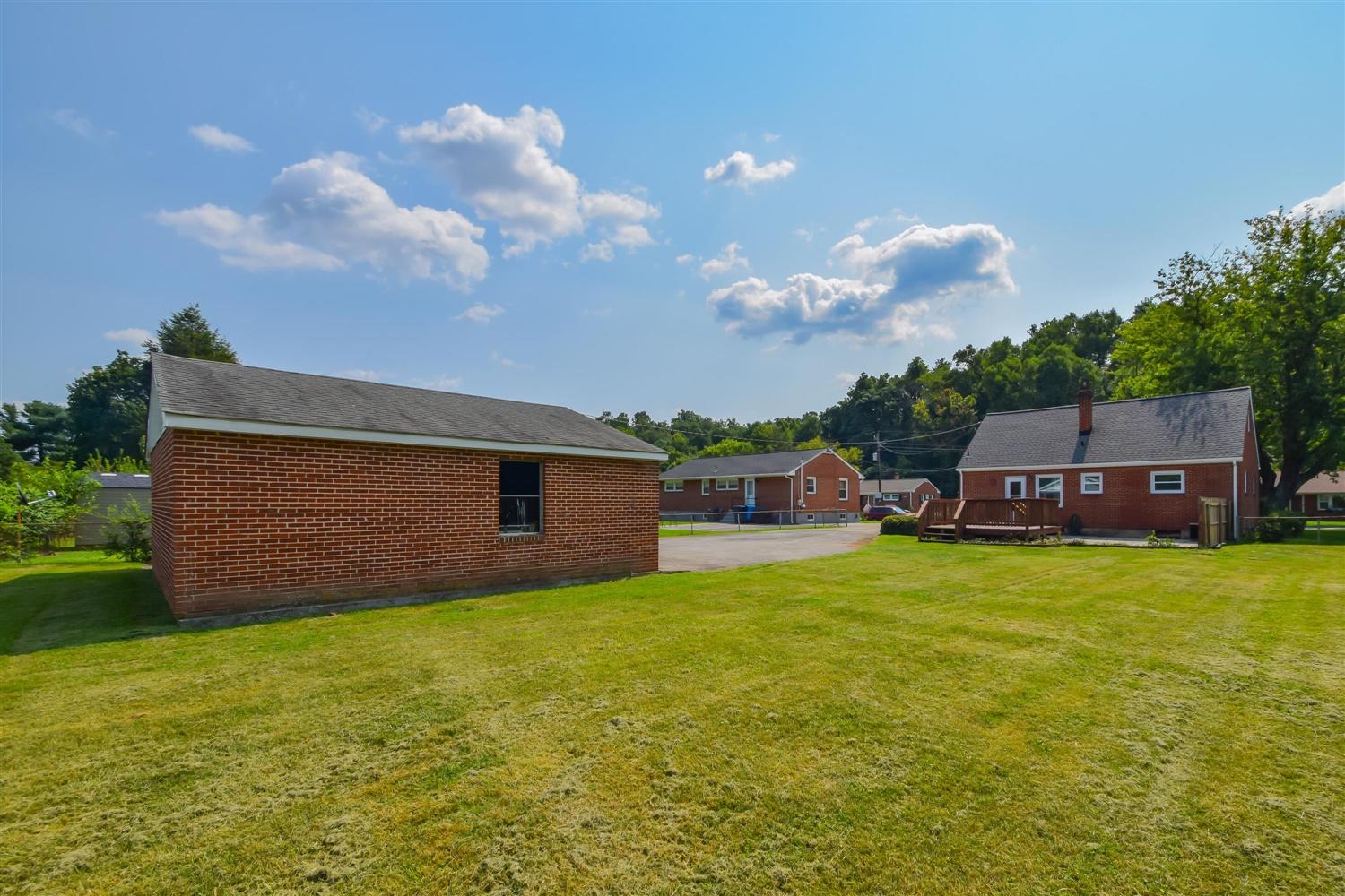 2027 Laura Road Northwest Roanoke, VA 24017 - Photo 21 of 26 a front view of a house with a garden and yard