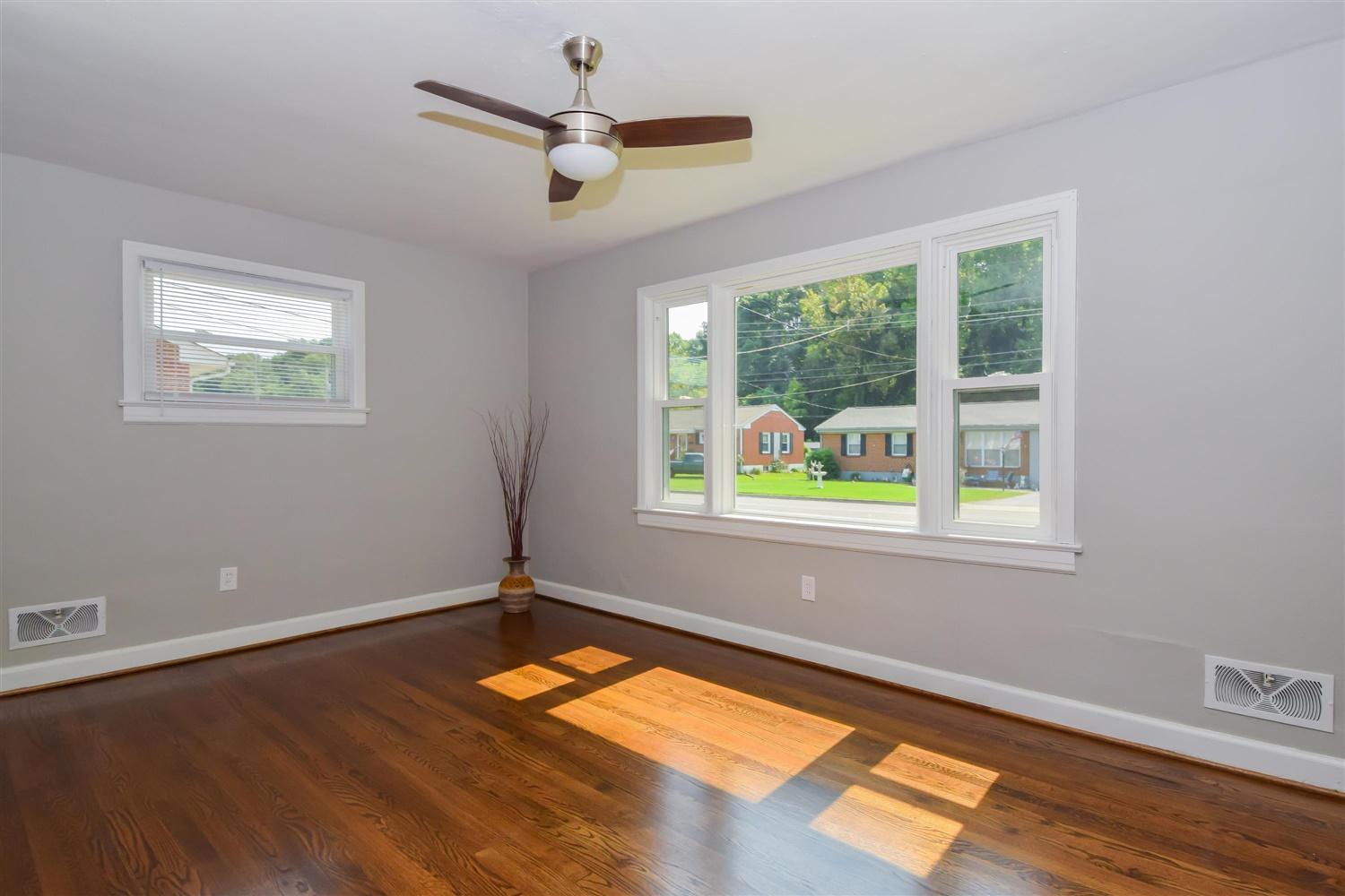 2027 Laura Road Northwest Roanoke, VA 24017 - Photo 4 of 26 a view of empty room with wooden floor and fan
