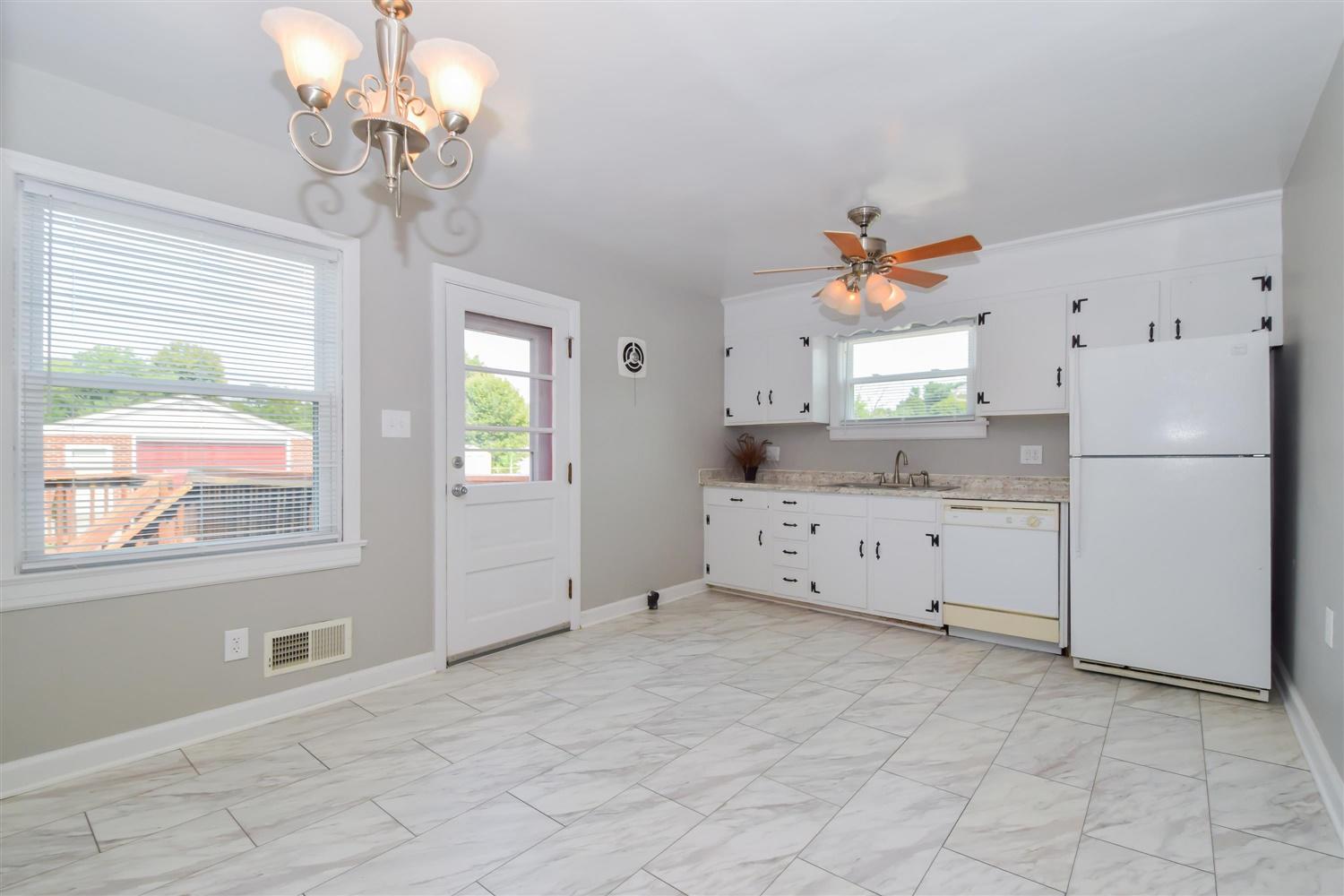 2027 Laura Road Northwest Roanoke, VA 24017 - Photo 6 of 26 a kitchen with stainless steel appliances a refrigerator and a chandelier