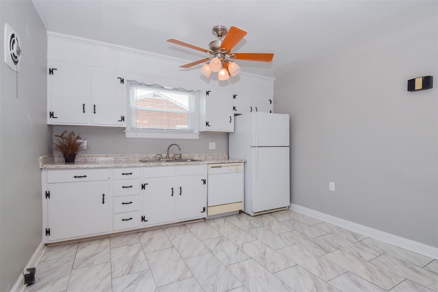 2027 Laura Road Northwest Roanoke, VA 24017 - Photo 8 of 26 a kitchen with granite countertop white cabinets and white appliances