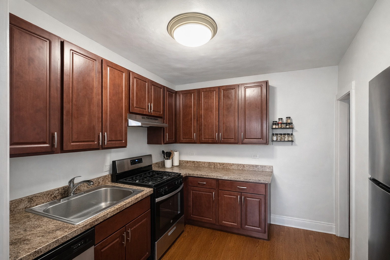 2461 North Clark Street, Unit 2 Chicago, IL 60614 - Photo 5 of 9 a kitchen with sink cabinets and stainless steel appliances