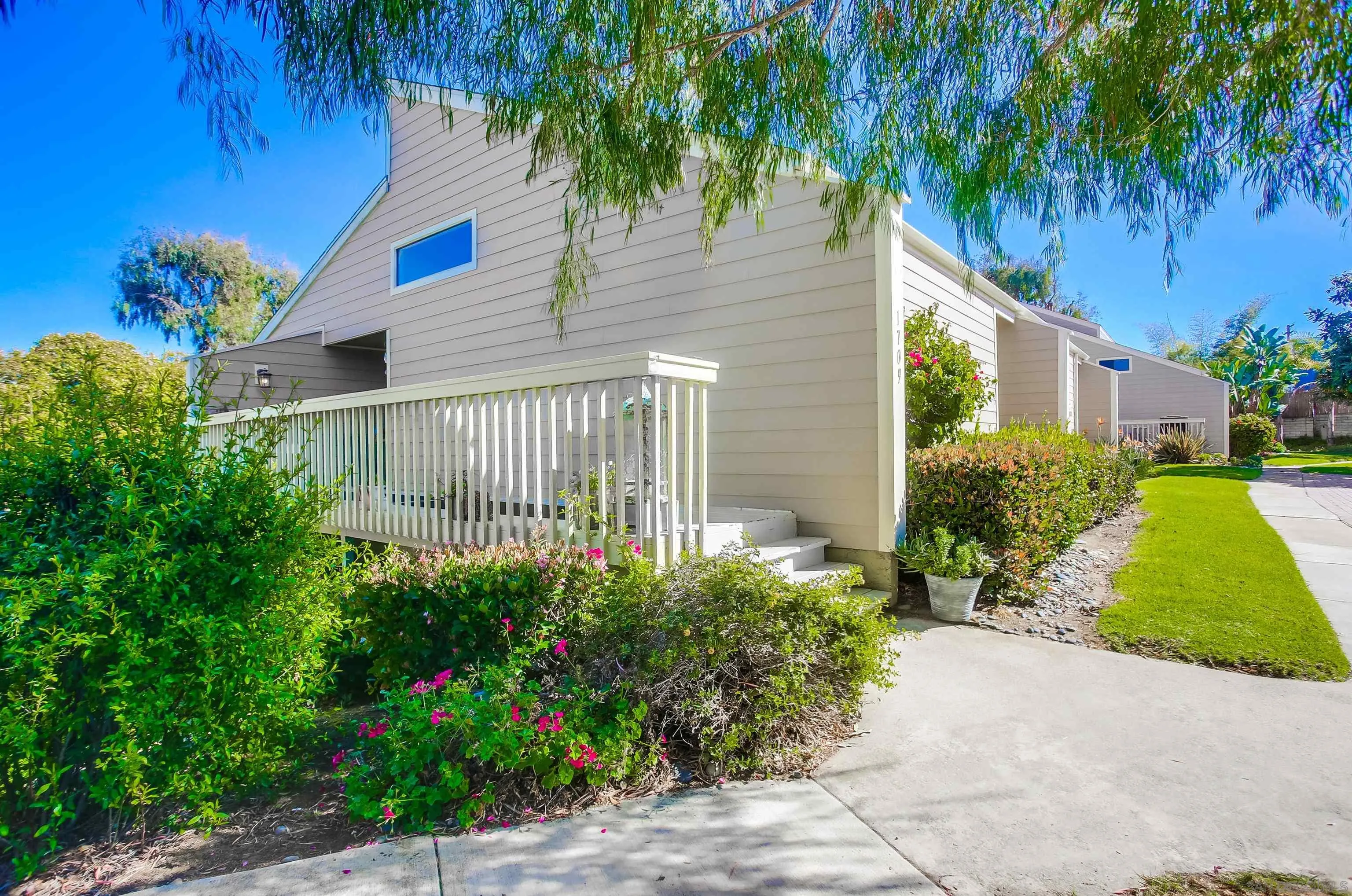 1709 Kennington Road Encinitas, CA 92024 - Photo 1 of 25 a front view of a house with a garden