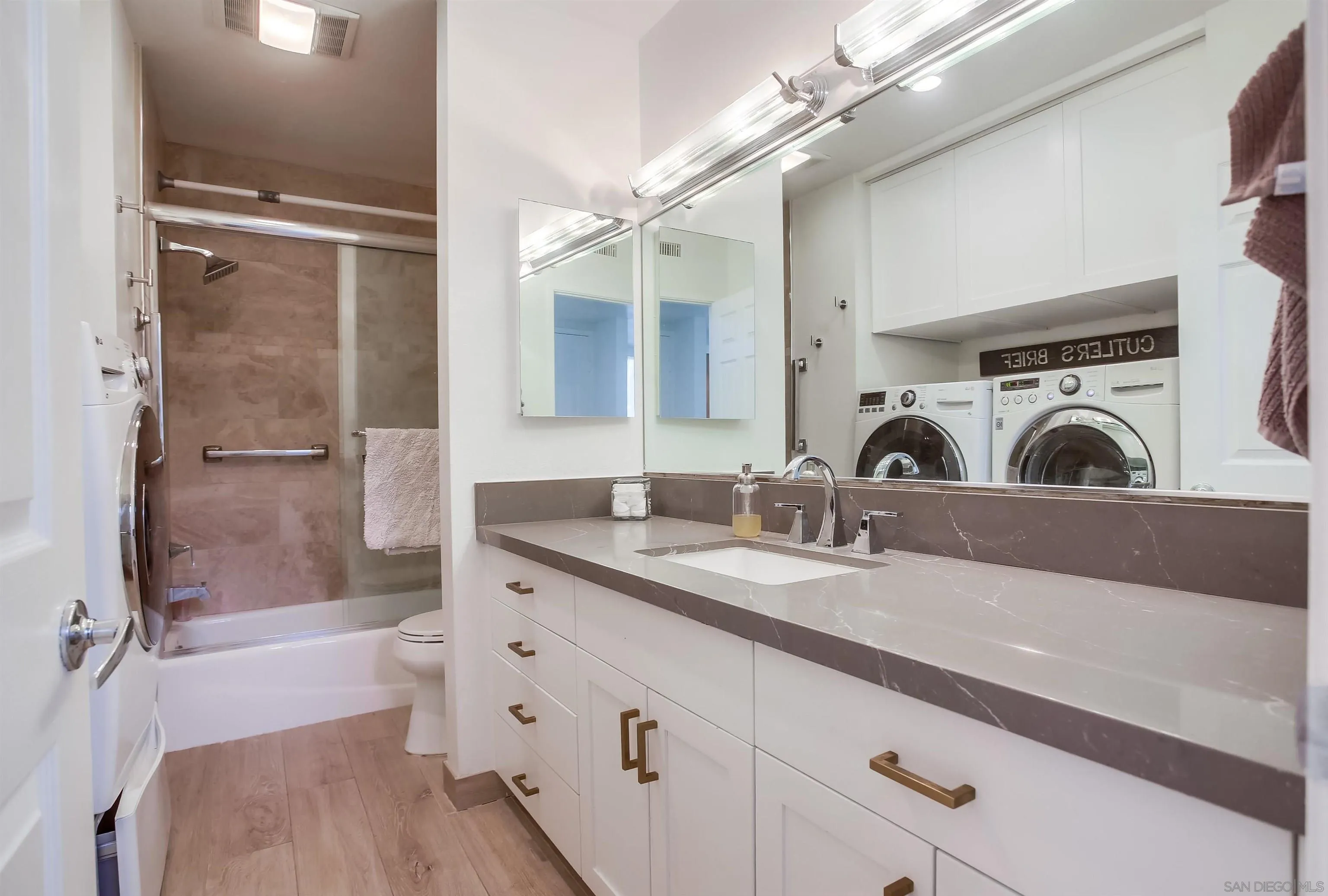 1709 Kennington Road Encinitas, CA 92024 - Photo 17 of 25 a bathroom with a sink a toilet a mirror and shower
