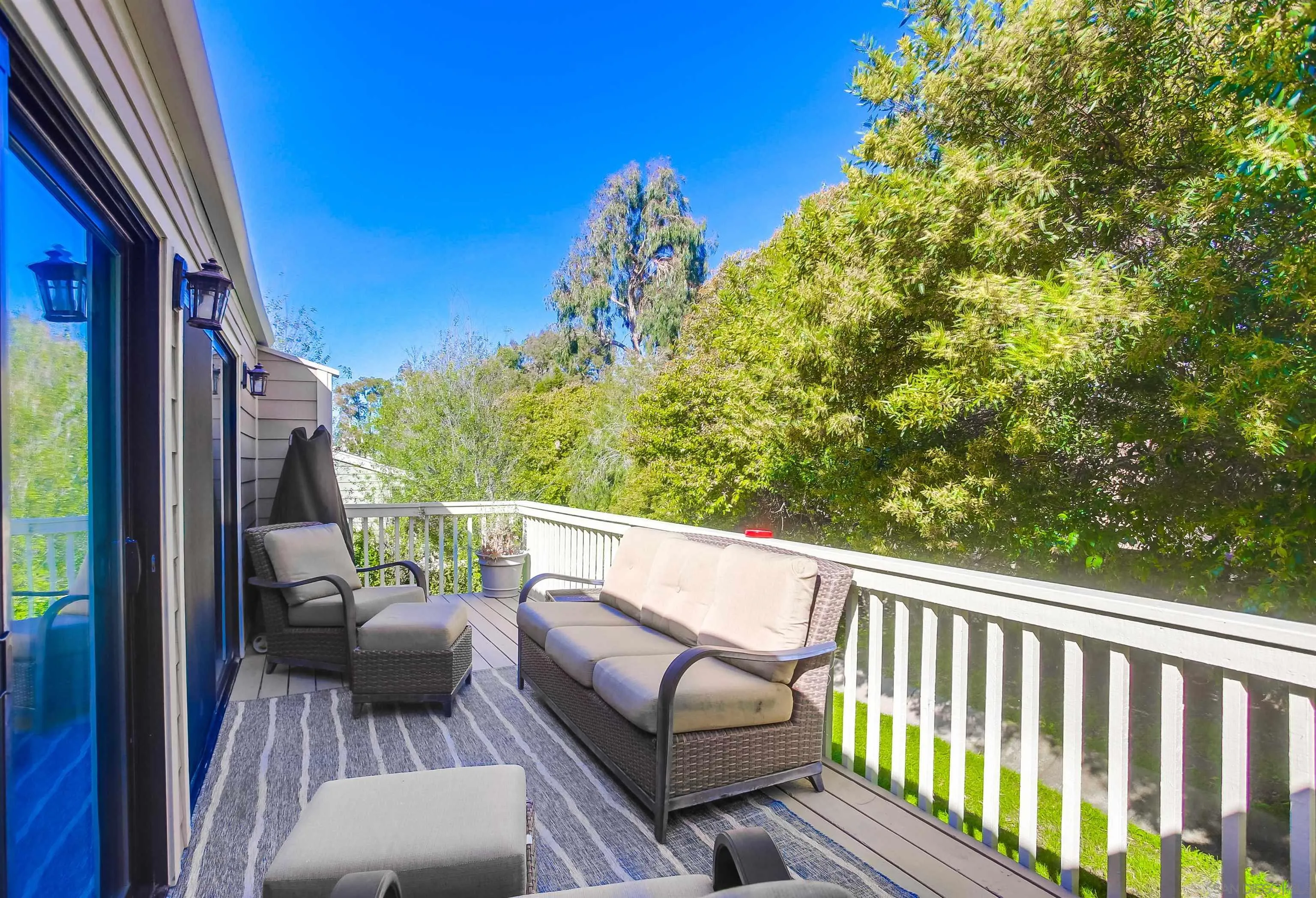 1709 Kennington Road Encinitas, CA 92024 - Photo 19 of 25 a balcony with wooden floor and outdoor seating