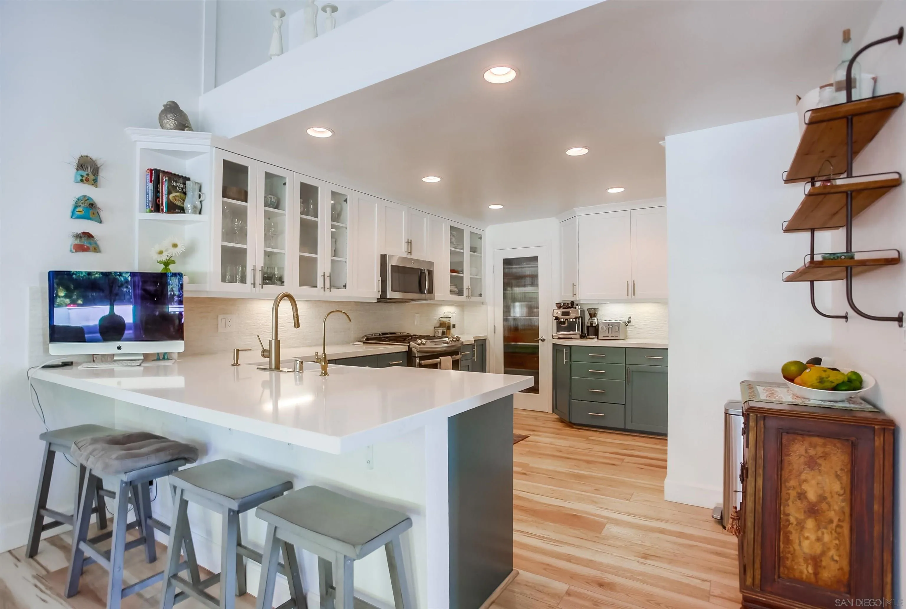 1709 Kennington Road Encinitas, CA 92024 - Photo 2 of 25 a kitchen with stainless steel appliances granite countertop a refrigerator a stove top oven a sink dishwasher and white cabinets with wooden floor