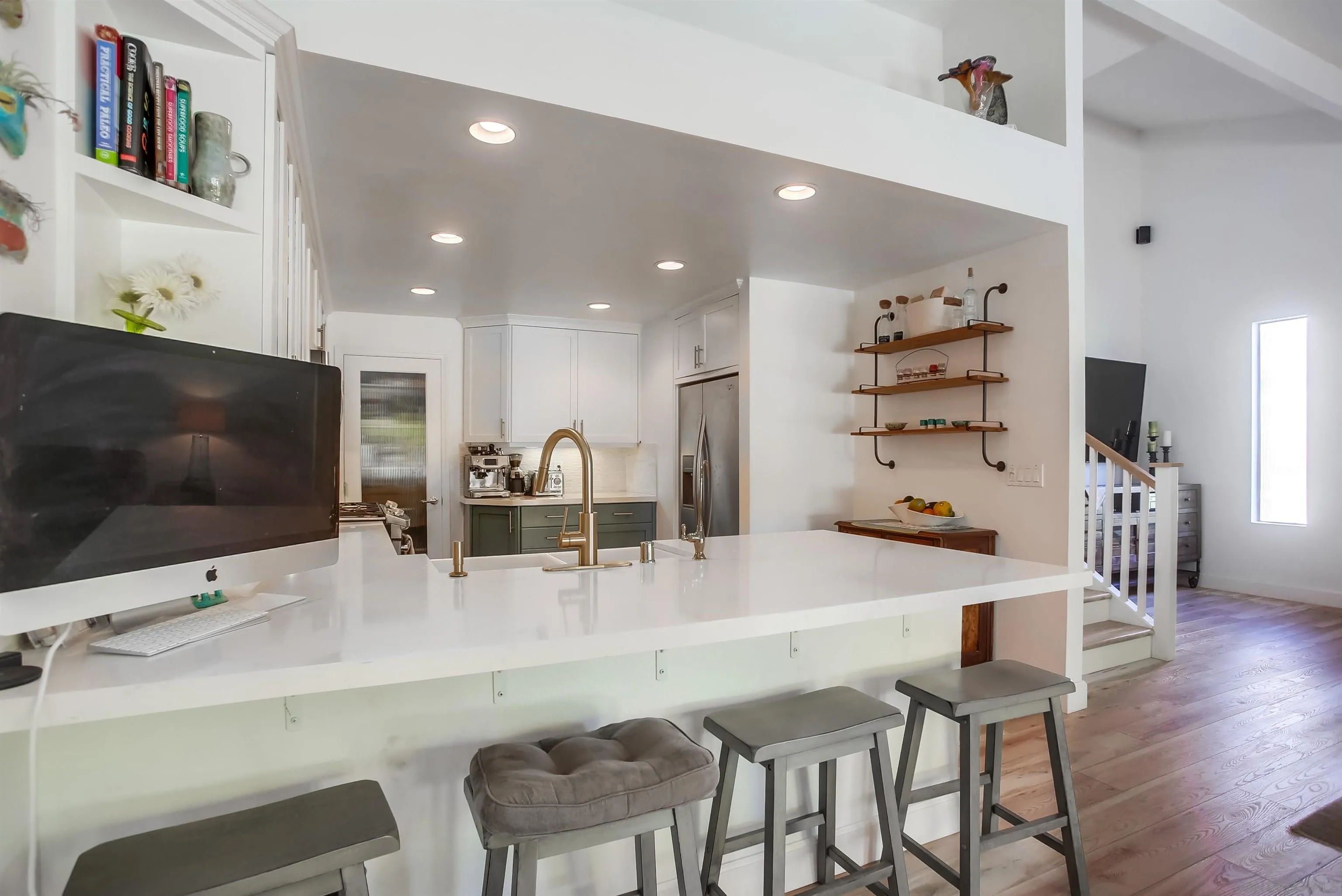 1709 Kennington Road Encinitas, CA 92024 - Photo 4 of 25 a kitchen with stainless steel appliances a dining table chairs refrigerator and a sink