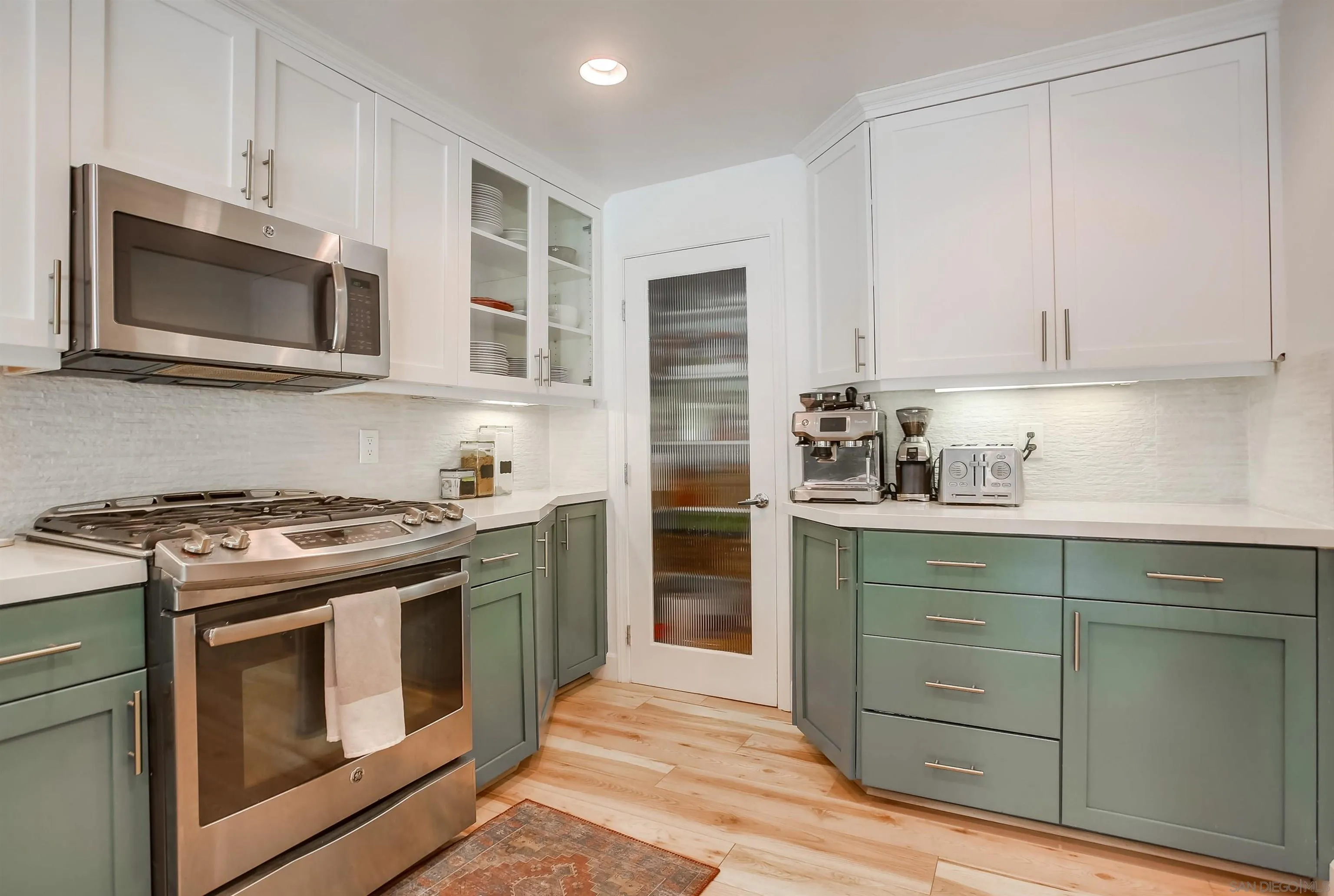 1709 Kennington Road Encinitas, CA 92024 - Photo 5 of 25 a kitchen with stainless steel appliances granite countertop a stove and a microwave