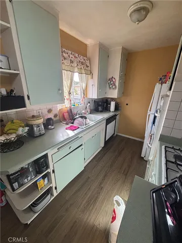 a kitchen with a sink appliances and cabinets