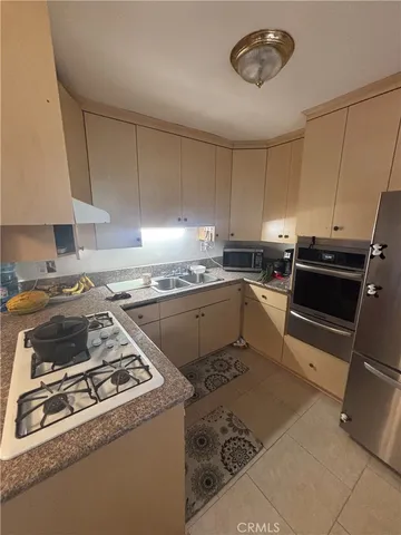 a kitchen with a stove a sink and a refrigerator