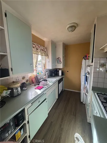 a kitchen with stainless steel appliances a sink stove and cabinets