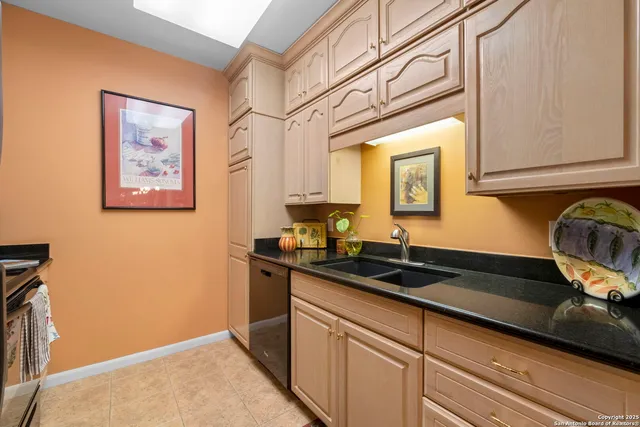 a kitchen with a sink and cabinets