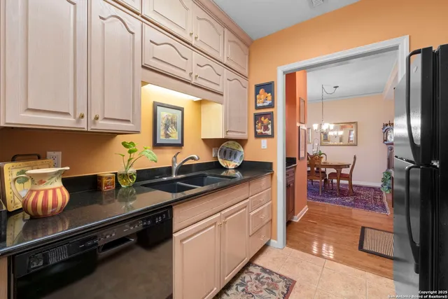 a kitchen with stainless steel appliances granite countertop a sink stove and cabinets
