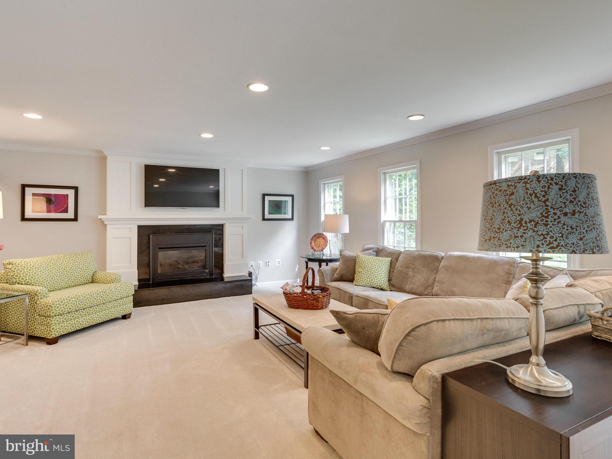 1802 Batten Hollow Road Vienna, VA 22182 - Photo 13 of 30 a living room with furniture a flat screen tv and a fireplace