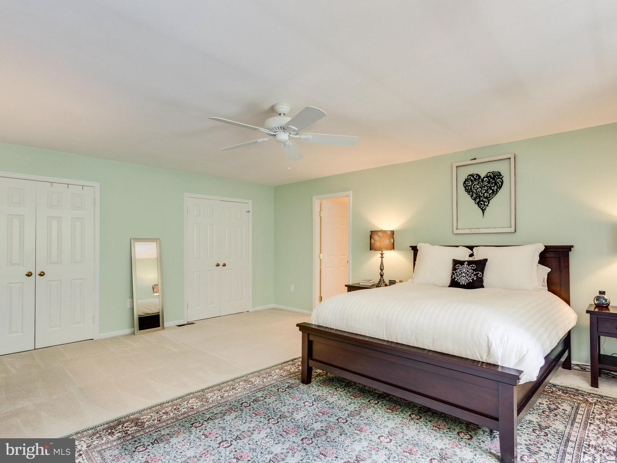 1802 Batten Hollow Road Vienna, VA 22182 - Photo 17 of 30 a bedroom with a bed and a chandelier